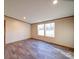 Bedroom featuring neutral walls, durable floors, and natural light from a large window at 1085 Cedar Hill Dr, Rockwell, NC 28138
