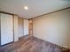 Bedroom featuring neutral walls, durable floors, and convenient access to other rooms at 1085 Cedar Hill Dr, Rockwell, NC 28138