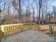 A newly constructed wooden deck overlooks a private, wooded backyard, perfect for outdoor entertaining at 1085 Cedar Hill Dr, Rockwell, NC 28138