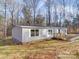 Charming single-story home with a welcoming front porch and white trim, nestled in a wooded setting at 1085 Cedar Hill Dr, Rockwell, NC 28138