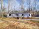 Charming single-story home with gray siding, white trim, and a newly built wooden porch and steps at 1085 Cedar Hill Dr, Rockwell, NC 28138