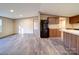 View of living room flowing into kitchen area, showcasing new floors and a modern, open design at 1085 Cedar Hill Dr, Rockwell, NC 28138