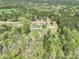 Aerial view showcasing a home surrounded by lush forestry in a serene, wooded setting at 1766 Duckwood Rd, Lancaster, SC 29720