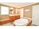 Bright bathroom featuring a soaking tub, double vanity, and a separate shower at 1766 Duckwood Rd, Lancaster, SC 29720