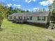 Charming single-story home featuring a spacious wooden deck, green shutters, and a well-maintained lawn at 1766 Duckwood Rd, Lancaster, SC 29720