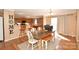 Open kitchen and dining area with wood cabinets, breakfast bar, and access to the backyard at 1766 Duckwood Rd, Lancaster, SC 29720