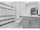 Bathroom showcasing a tub with a striped curtain, vanity with gray cabinets and white countertops at 1801 Pin Oak Ct, Fort Mill, SC 29715