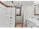 Bathroom showcasing a shower/tub combo with a vanity and wood trim at 201 Indian Hill Rd, Union Grove, NC 28689