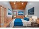 This bedroom features a wooden ceiling, wood paneled walls, and a large window at 201 Indian Hill Rd, Union Grove, NC 28689