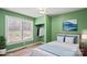Bright bedroom with green walls, large window, and open closet at 201 Indian Hill Rd, Union Grove, NC 28689