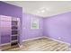 This purple bedroom includes a window and open closet at 201 Indian Hill Rd, Union Grove, NC 28689