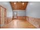 This bedroom features a wooden ceiling, wood paneled walls, and wood floor at 201 Indian Hill Rd, Union Grove, NC 28689