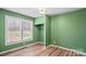 Bright bedroom with green walls, large window, and closet at 201 Indian Hill Rd, Union Grove, NC 28689