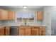 Bright kitchen featuring wood cabinets, granite countertops, and a large window at 201 Indian Hill Rd, Union Grove, NC 28689