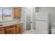 View of the kitchen area featuring wood cabinets, granite countertops, and a pantry door at 201 Indian Hill Rd, Union Grove, NC 28689