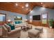 Cozy living room with a fireplace, wood ceiling, recessed lighting, and large windows at 201 Indian Hill Rd, Union Grove, NC 28689