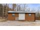 Functional outbuilding or shed with a metal roof and double doors, providing extra storage space at 201 Indian Hill Rd, Union Grove, NC 28689