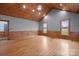 Spacious room featuring hardwood floors, wood trim, neutral colored walls, and bright windows at 201 Indian Hill Rd, Union Grove, NC 28689