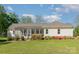 Screened porch with colorful flowering bushes at 202 Oakwood St, Stanfield, NC 28163