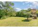 Spacious backyard with lush greenery and mature trees at 202 Oakwood St, Stanfield, NC 28163