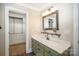 Bathroom with walk in closet and vanity with framed mirror at 202 Oakwood St, Stanfield, NC 28163
