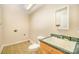 Bathroom with a toilet, a sink, and a mirror on the wall at 202 Oakwood St, Stanfield, NC 28163