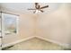 Bedroom with a ceiling fan, a window, and carpeted floors at 202 Oakwood St, Stanfield, NC 28163