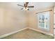 Bedroom with a ceiling fan, a window, and carpeted floors at 202 Oakwood St, Stanfield, NC 28163