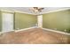 Bedroom featuring a neutral color, a ceiling fan, and multiple doorways at 202 Oakwood St, Stanfield, NC 28163