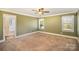 Spacious primary bedroom with a ceiling fan and two windows at 202 Oakwood St, Stanfield, NC 28163