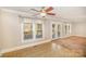 Sunny dining area with large windows and a ceiling fan at 202 Oakwood St, Stanfield, NC 28163