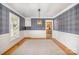 Elegant dining room with plaid wallpaper, wooden floors, carpet, and built-in shelving at 202 Oakwood St, Stanfield, NC 28163