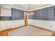 Elegant dining room with plaid wallpaper, wooden floors, carpet, and built-in shelving at 202 Oakwood St, Stanfield, NC 28163