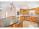 Open kitchen with stainless steel appliances, breakfast bar, and ample cabinet space at 202 Oakwood St, Stanfield, NC 28163