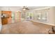 Open-concept living room and kitchen area with a breakfast bar and lots of natural light at 202 Oakwood St, Stanfield, NC 28163