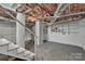 Unfinished basement features white-painted walls, exposed ceiling, and concrete floors at 203 E 22Nd St, Kannapolis, NC 28083
