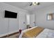 Bedroom with white trim, a flat screen TV, and a peek into another room at 203 E 22Nd St, Kannapolis, NC 28083