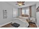 Cozy bedroom with a ceiling fan, window with curtains, and a beautiful throw blanket at 203 E 22Nd St, Kannapolis, NC 28083