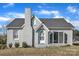 Charming brick home with a unique architectural design, featuring a prominent chimney and arched windows at 203 E 22Nd St, Kannapolis, NC 28083