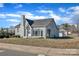 Exterior home view featuring mature landscaping, a brick facade, and easy street access at 203 E 22Nd St, Kannapolis, NC 28083