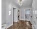 Well lit hallway with hardwood floors, several doors, and access to a bathroom at 203 E 22Nd St, Kannapolis, NC 28083