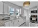 Bright kitchen featuring white cabinets, stainless steel appliances, and granite countertops at 203 E 22Nd St, Kannapolis, NC 28083