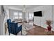 Elegant living room with hardwood floors, a modern chandelier, and a decorative accent wall at 203 E 22Nd St, Kannapolis, NC 28083