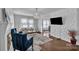 Elegant living room with hardwood floors, a modern chandelier, and a decorative accent wall at 203 E 22Nd St, Kannapolis, NC 28083
