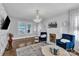 Bright living room with hardwood floors, a modern chandelier, and a decorative brick fireplace at 203 E 22Nd St, Kannapolis, NC 28083