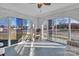 Bright sunroom featuring brick walls, a ceiling fan, and large windows offering plenty of natural light at 203 E 22Nd St, Kannapolis, NC 28083