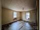 The bedroom features herringbone flooring and two windows that provide natural lighting at 2124 W C St, Kannapolis, NC 28081