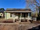 This home offers a quaint covered front porch with white railings and brick accents, welcoming you to a cozy retreat at 2124 W C St, Kannapolis, NC 28081