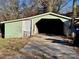 This detached garage has a metal door and a concrete floor. It appears to have a newer roof at 2124 W C St, Kannapolis, NC 28081