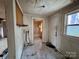 Functional hallway with tiled floors leading to a bathroom, ready for customization and renovation at 2124 W C St, Kannapolis, NC 28081